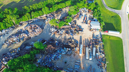 Small town recycling center near service road, pile of ferrous, nonferrous scrap metals, vehicle...