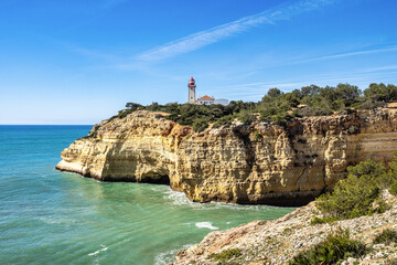 Portuguese coast in Benagil, Algarve, Portugal. Alfanzina Lighthouse. Seven Hangging Valleys Trail.