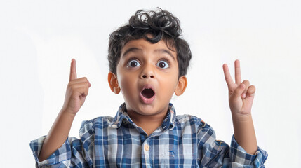 indian boy with a surprised expression and pointing upwards
