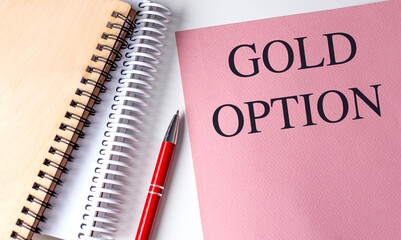 GOLD OPTION text on pink paper with notebooks