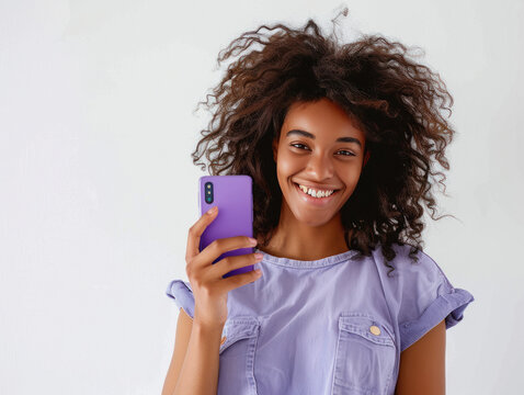young beautiful woman holding smartphone on isolated background