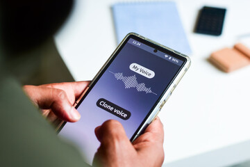 Man using mobile applications to clone voice. Selective focus, cyber crime concept.