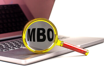 MBO word on magnifier on laptop , white background