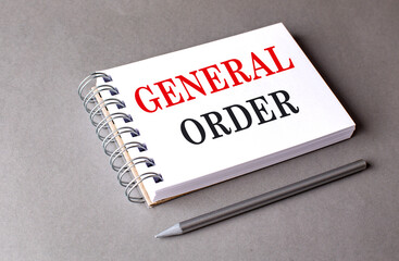 GENERAL ORDER text on notebook on grey background