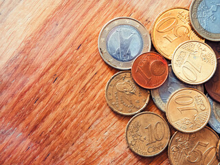 Financial Concept. Euro coins spread on wood, economic theme. Uses for Banking websites, investment...