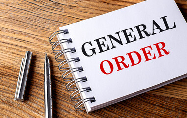 GENERAL ORDER text on notebook on wooden background