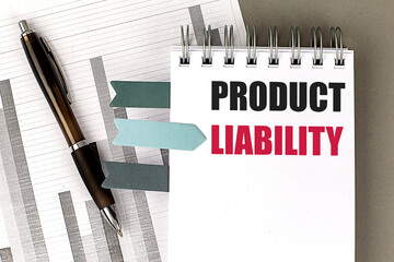 PRODUCT LIABILITY text on notebook with chart on gray background