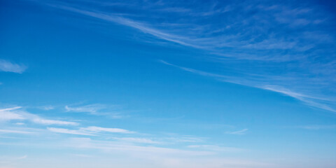 A serene blue sky with wispy clouds, suggesting calmness, ideal for backgrounds or meditation visuals. Expansive azure sky with delicate cloud streaks, evoking tranquility.