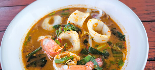 Seafood noodles in a white bowl