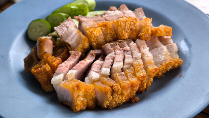 Crispy pork rice on a blue plate on the dining table