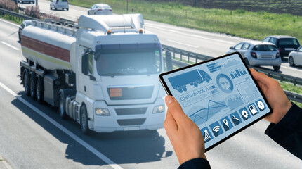 Manager with a digital tablet on the background of truck. Fleet management..
