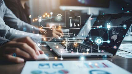 A group of business professionals are working together in an office setting, using modern technology such as a laptop for financial data analysis, visualization, and strategic planning