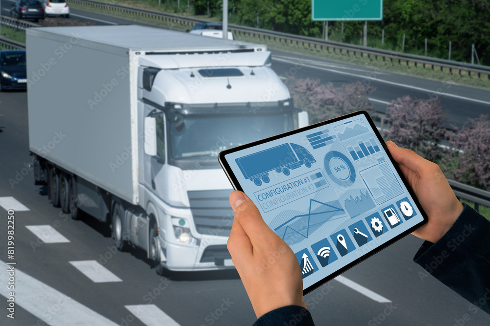 Poster Manager with a digital tablet on the background of truck. Fleet management..