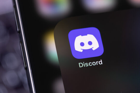 Discord icon app on a screen smartphone iPhone. Discord is a cross-platform proprietary instant messaging system with support for VoIP and video conferencing. Batumi, Georgia - February 11, 2024