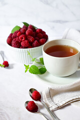 Juicy ripe raspberries in a plate on a white backgroundripe raspberries in a white plate on a white background, vitamins for the body