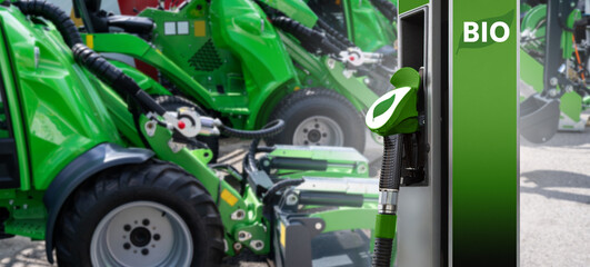 Biofuel filling station on a background of green construction machines. Decarbonization of heavy...