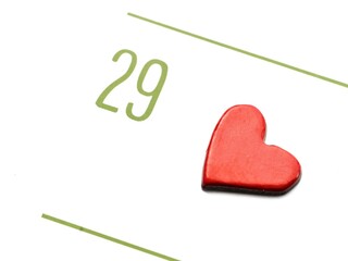 A close-up view of the 29th day of a month on a calendar, with a red heart nearby.
