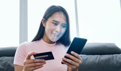 Female using mobile smartphone scanning  face ID to unlock phone security with facial recognition technology for identification, access to financial bank assets cash and money.