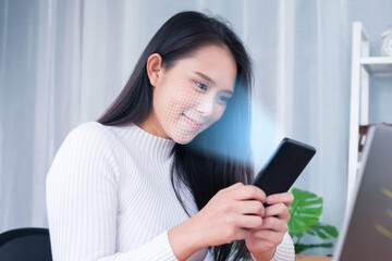 Asian female using mobile smartphone scanning  face ID to unlock phone security with facial...