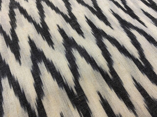Closeup of black and white zigzag woven ikat on cotton fabric