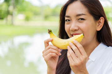 Banana Healthy eating young woman workout holding organic banana fruit healthy lifestyle. Wellness...