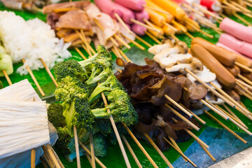 Various meatball skewers and vegetables skewers for shabu, grilled, steamed in the Thai market.