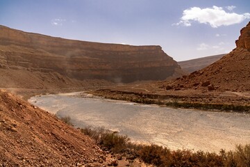 landscape view of the semi-desert of the Ziz Valley and Ziz Valley Gorge and its dry riverbed