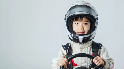 Young Boy Wearing Helmet Holding Steering Wheel