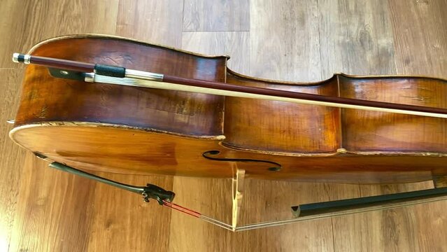 Cello Bow Stringed String Musical Instrument on Wooden Floor Classical Music 