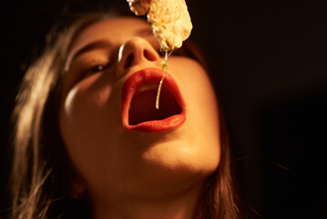 Girl with red lips sexy eating a slice of pizza