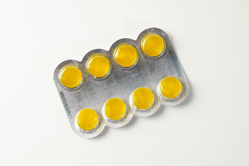Medical candies lozenges in blister pack isolated on white background