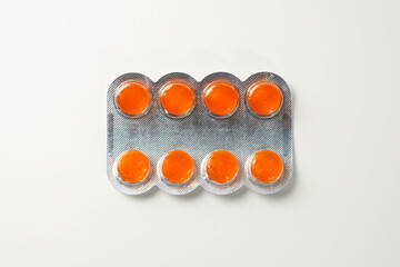 Medical candies lozenges in blister pack isolated on white background
