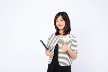 Naklejka premium Asian woman thumbs up while holding a tablet against a white background.