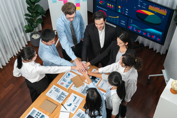 Multiracial business people make synergy hand stack together in meeting room as cooperation or team...