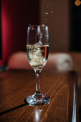 a splash of champagne from the glass where the wedding rings were thrown