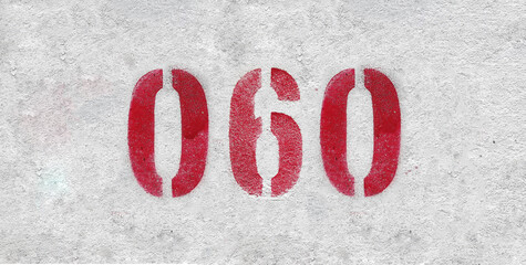 Red Number 060 on the white wall. Spray paint.