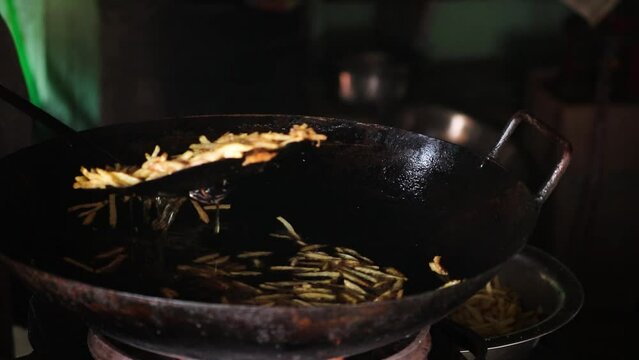 A man frying potato chips in Indian mela