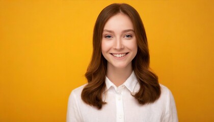 Portrait of a cheerful young woman wearing white shirt standing isolated over yellow background,...