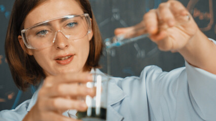 Closeup of young beautiful teacher focus on mixing chemical liquid at laboratory. Skilled scientist...