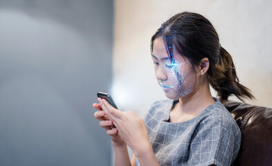 asian female using mobile smartphone scanning  face ID to unlock phone security access with facial recognition technology for biometric identification, future home living luxury tech.
