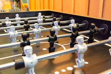 Football Table with White and Black Players on Opposite Sides
