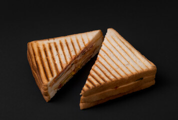 club sandwich on a wooden board on a dark background