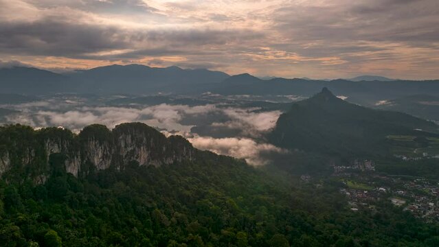 An aerial hyperlapse view peak of rocky hills Bukit tabur during morning.