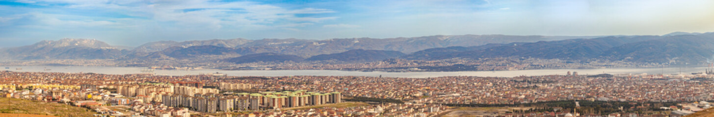 A very wide panoramic view of Kocaeli with its sea and mountains. Factory chimneys environmental...