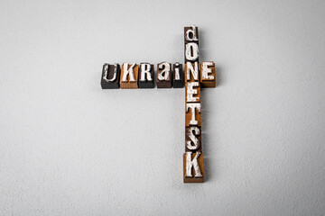 UKRAINE DONETSK. Alphabet blocks, crossword puzzle on gray textured background