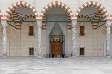 Symmetrical view of the arched and columned architectural structure in front of the entrance gate...