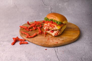 Dynamite prawns burger with Cheetos, lettuce, cheese and mayonnaise