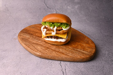 Beef patty burger with lettuce, fried onion, American cheese and jalapeno mayo