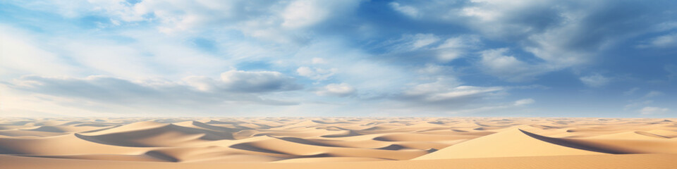 Naklejka premium Sand dunes under blue sky with white clouds, peaceful desert landscape