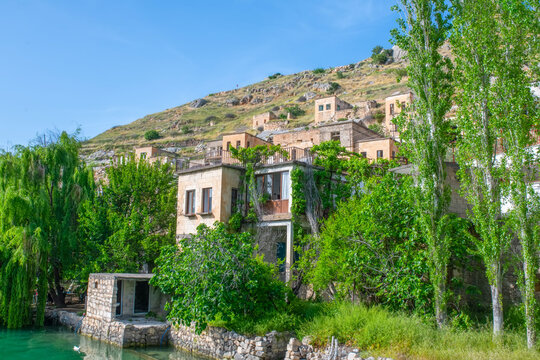 Halfeti village and its submerged minaret and Turkish flags of toursit boats sunken minaret in Halfeti - TURKEY. landscape photo